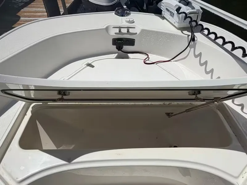 Slide: The Image of 2024 Boston Whaler 17 Montauk storage compartment with open lid. - 14