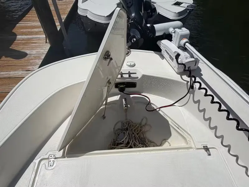 Slide: The Image of Boston Whaler 17 Montauk 2024 with open storage compartment and rope. - 15