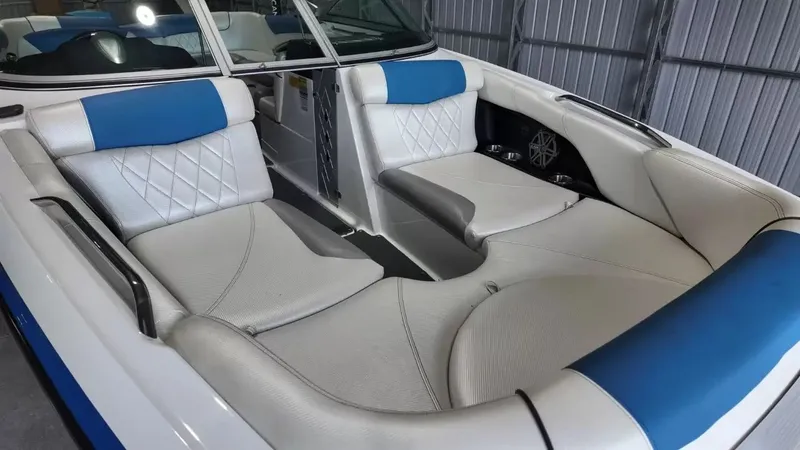 Slide: The Image of Interior of a 2012 MasterCraft X-45 boat with blue and white seating. - 11