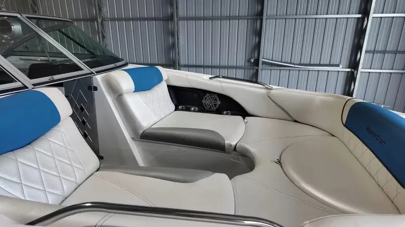 Slide: The Image of Interior of a 2012 MasterCraft X-45 boat with blue and white seating. - 12