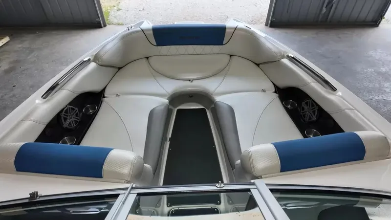Slide: The Image of Interior of a 2012 MasterCraft X-45 boat with blue and white seating. - 13