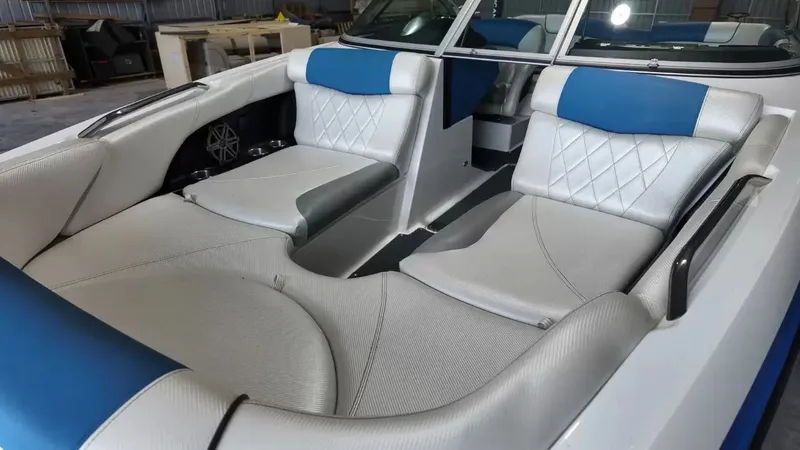 Slide: The Image of Interior of a 2012 MasterCraft X-45 boat with blue and white seating. - 15