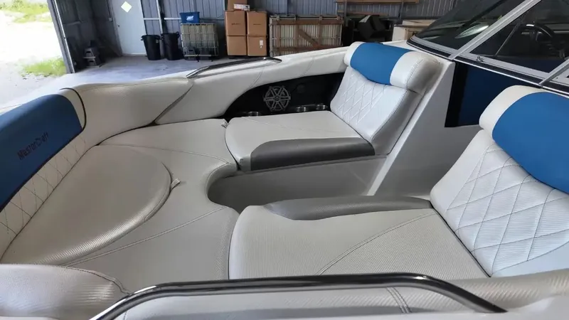 Slide: The Image of Interior of a 2012 MasterCraft X-45 boat with white and blue seating. - 16