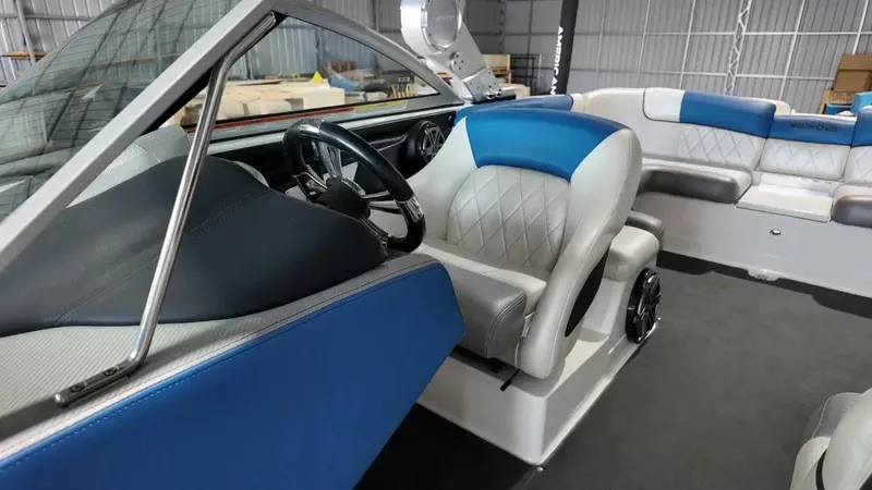 Slide: The Image of Interior of a 2012 MasterCraft X-45 boat with blue and gray seating. - 17