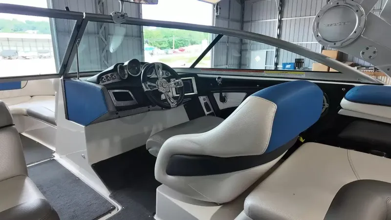 Slide: The Image of Interior of a 2012 MasterCraft X-45 boat with blue and white seating. - 18