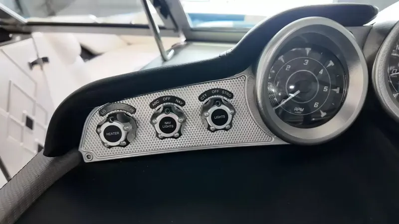 Slide: The Image of Dashboard of a 2012 MasterCraft X-45 with tachometer and switches. - 20