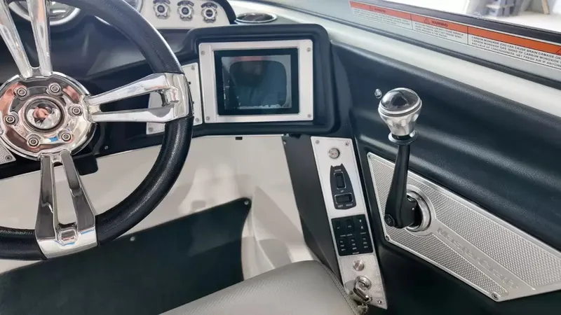 Slide: The Image of Interior of a 2012 MasterCraft X-45 boat with steering wheel and controls. - 23