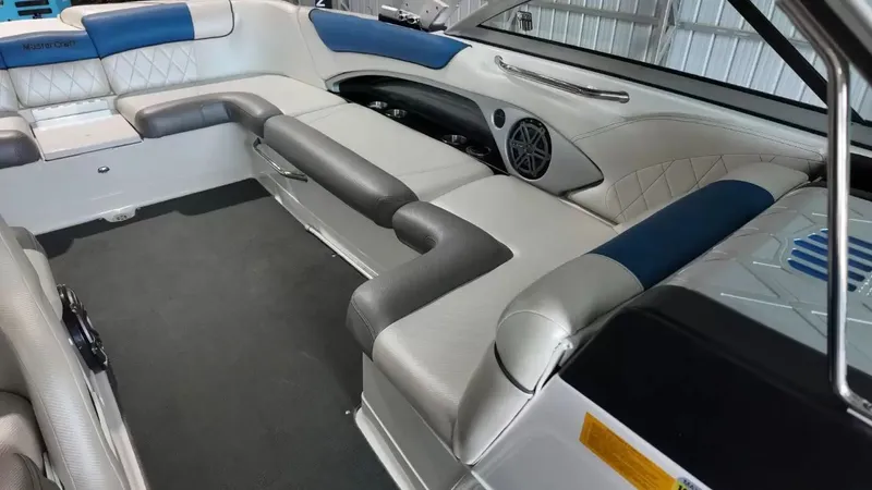 Slide: The Image of Interior of a 2012 MasterCraft X-45 boat with blue and gray seating. - 24