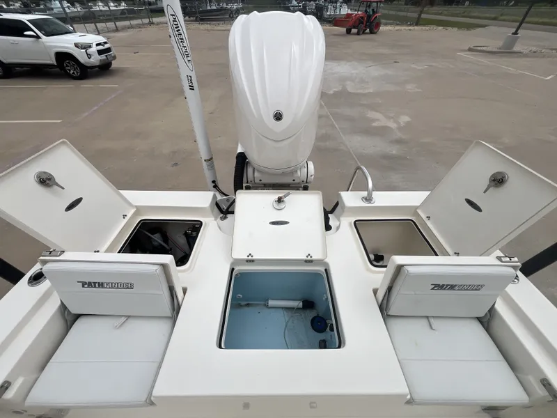 Slide: The Image of 2022 Pathfinder 2400 boat with open storage compartments and motor. - 22