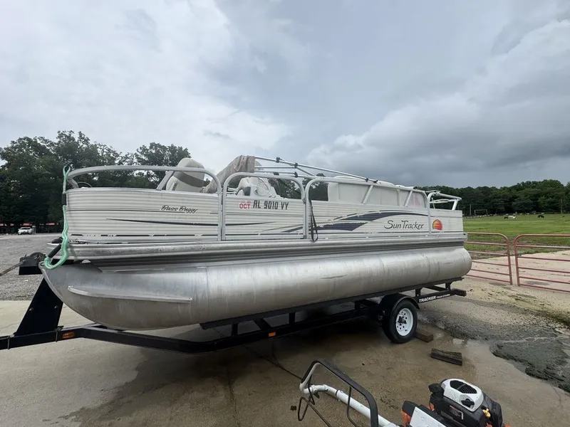 Slide: The Image of 2020 Sun Tracker Party Barge 22 RF DLX on trailer, cloudy sky. - 2