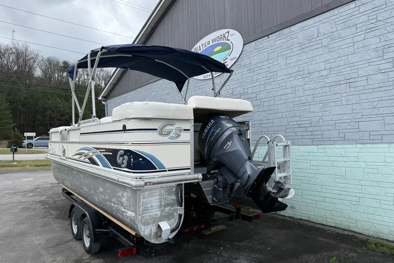Slide: The Image of 2007 SunCatcher LX 22 SE pontoon boat with Yamaha motor, parked outside a building. - 4