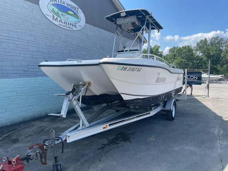 Slide: The Image of 2007 ProKat CS200 boat on trailer outside marine shop. - 2