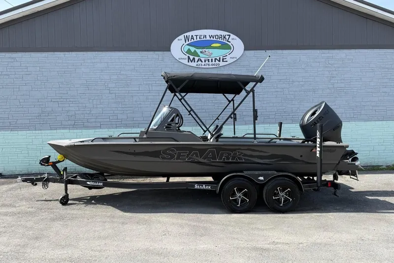 The Image of 2026 SeaArk Protege 200 boat in front of a marine shop. - 1