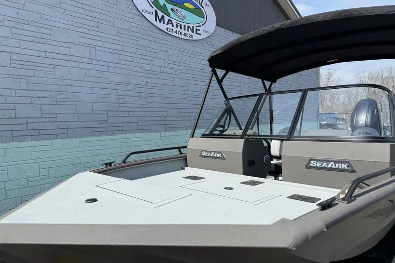 Slide: The Image of 2026 SeaArk Protege 200 boat outside a marine shop. - 3