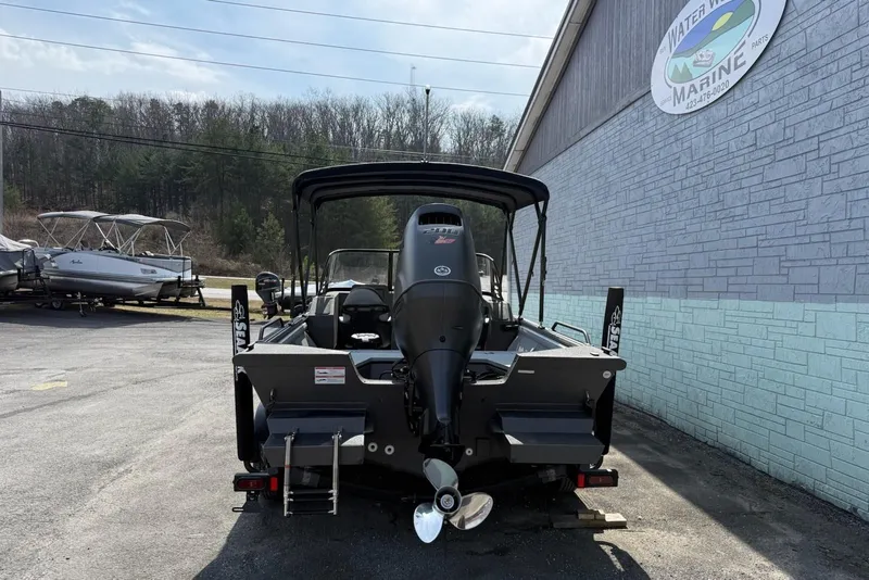 Slide: The Image of Rear view of a 2026 SeaArk Protege 200 boat in a parking lot. - 6