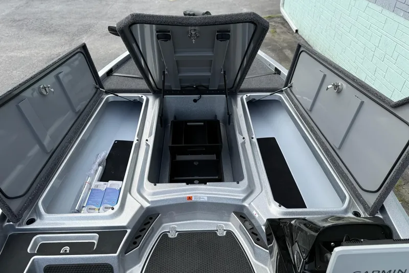 Slide: The Image of iKon VLX21 2026 boat with open storage compartments and Garmin equipment. - 11