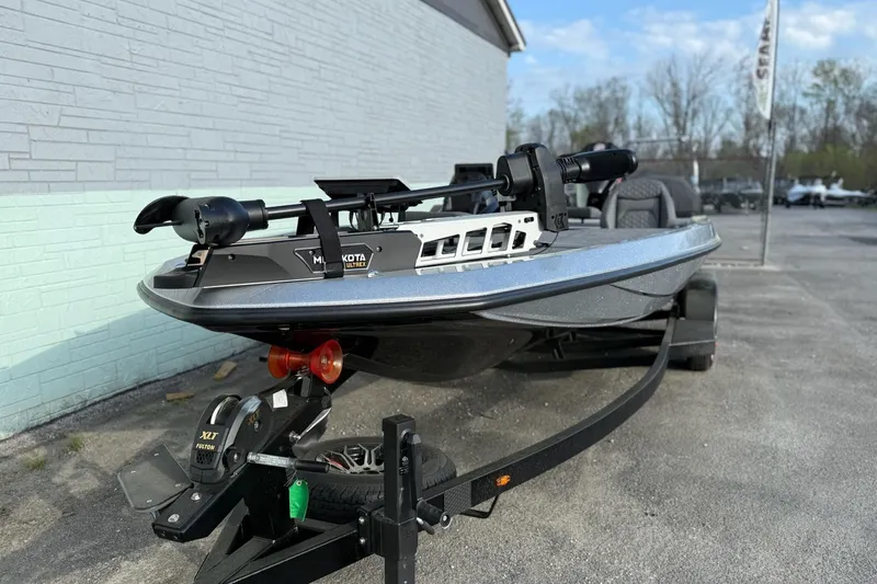 Slide: The Image of iKon VLX21 2026 boat on trailer, gray exterior wall. - 2