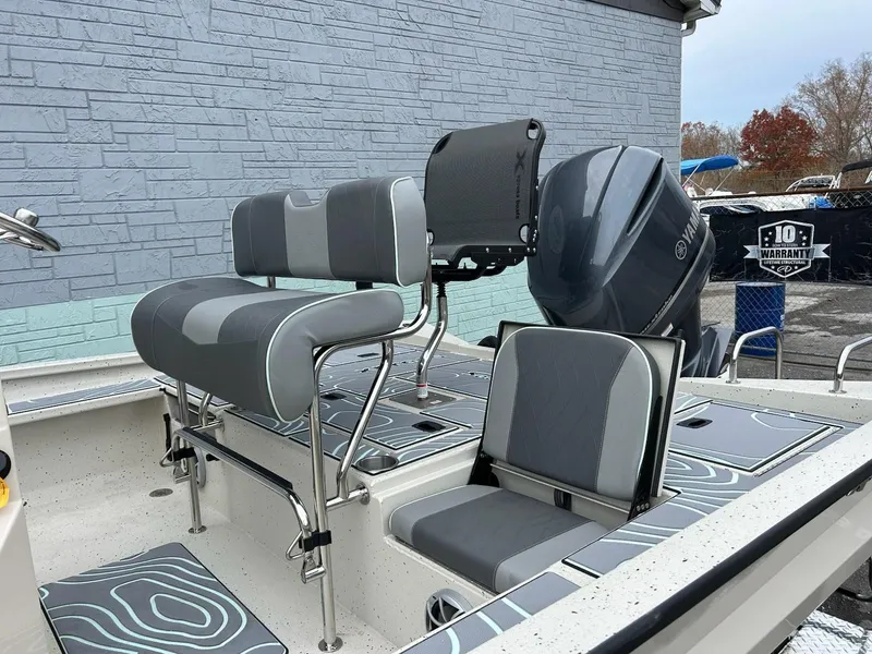 Slide: The Image of 2025 Xpress X23 Bay Lounge boat with Yamaha engine, gray seating. - 8