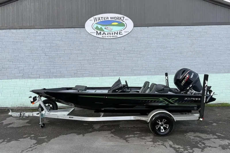 The Image of 2026 Xpress H18 boat on trailer outside marine shop. - 1