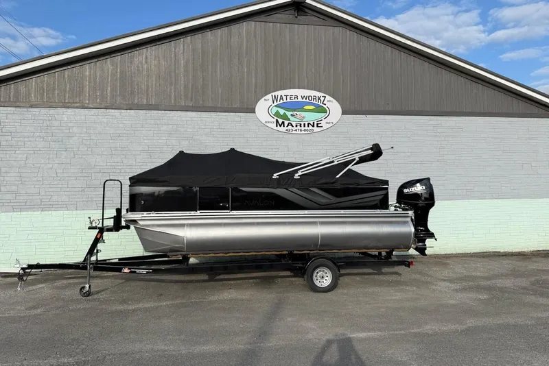 Slide: The Image of 2025 Avalon VTX Quad Fish boat in front of marine shop. - 8