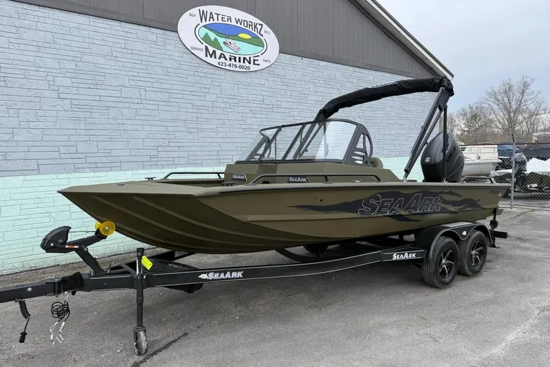 Slide: The Image of 2026 SeaArk Protege 200 boat on trailer outside marine shop. - 2