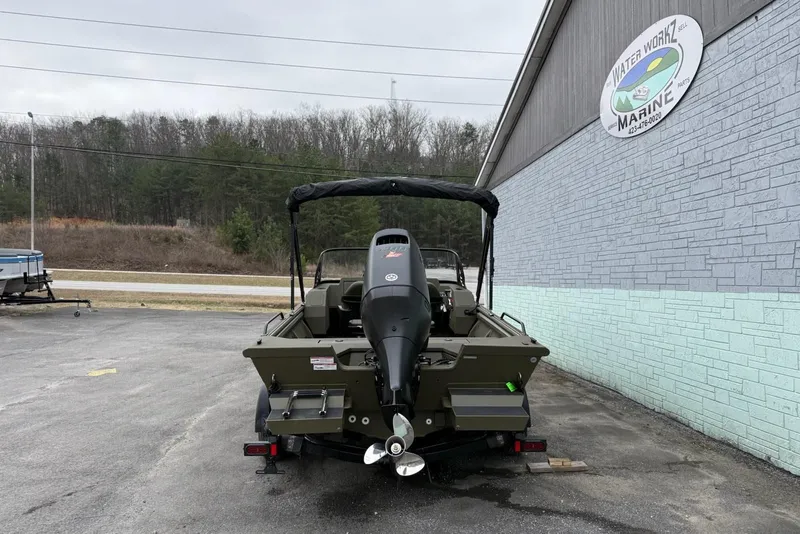 Slide: The Image of 2026 SeaArk Protege 200 boat on trailer outside marine shop. - 5