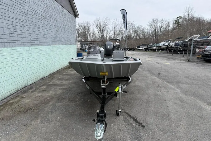 Slide: The Image of 2026 SeaArk Shadow 18 boat on trailer, gray exterior wall. - 3