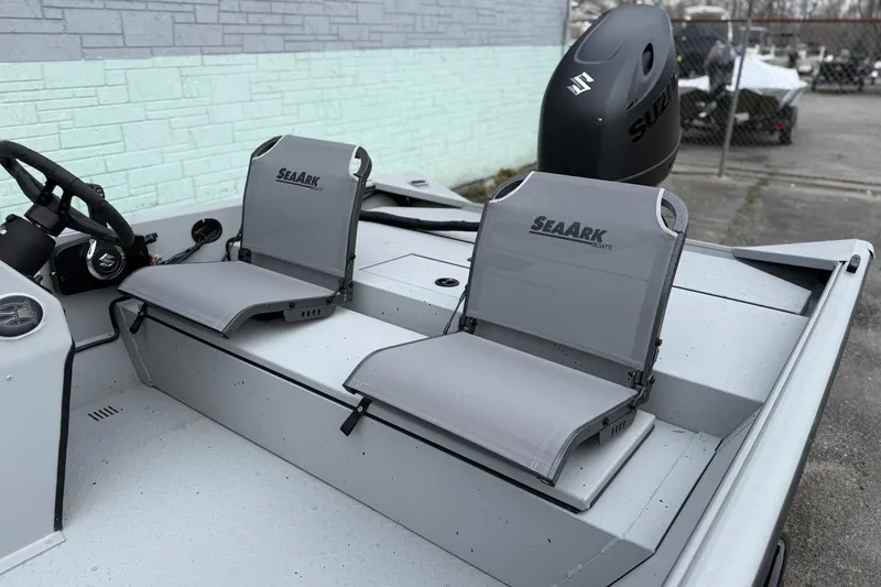 Slide: The Image of 2026 SeaArk Shadow 18 boat with Suzuki motor and gray seats. - 5