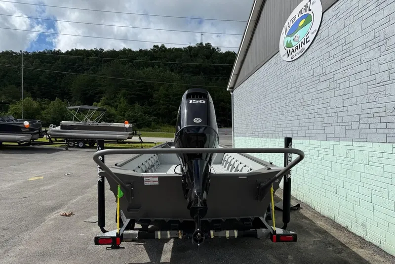 Slide: The Image of 2025 SeaArk 2472 Workhorse boat on trailer outside building. - 5