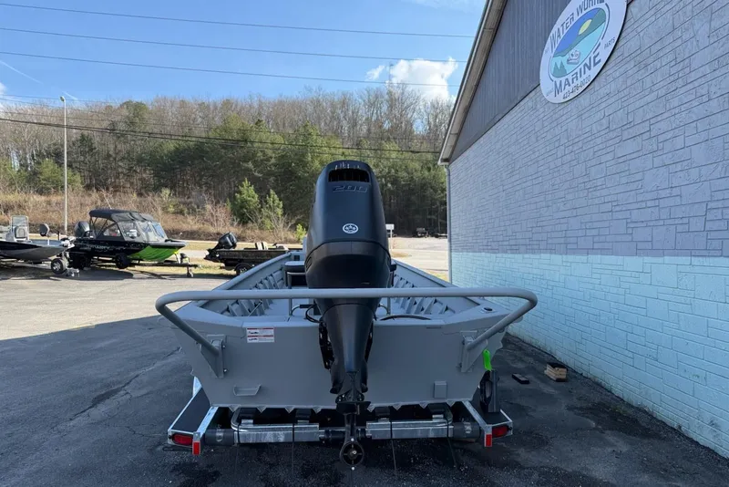 Slide: The Image of 2026 SeaArk 2472 Workhorse boat on trailer outside building. - 4