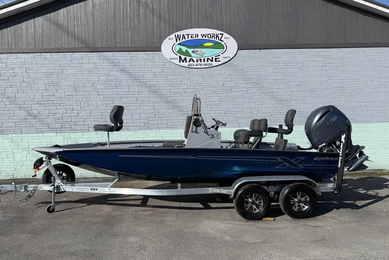 The Image of 2026 Xpress H20B Bay boat on trailer outside marine shop. - 1