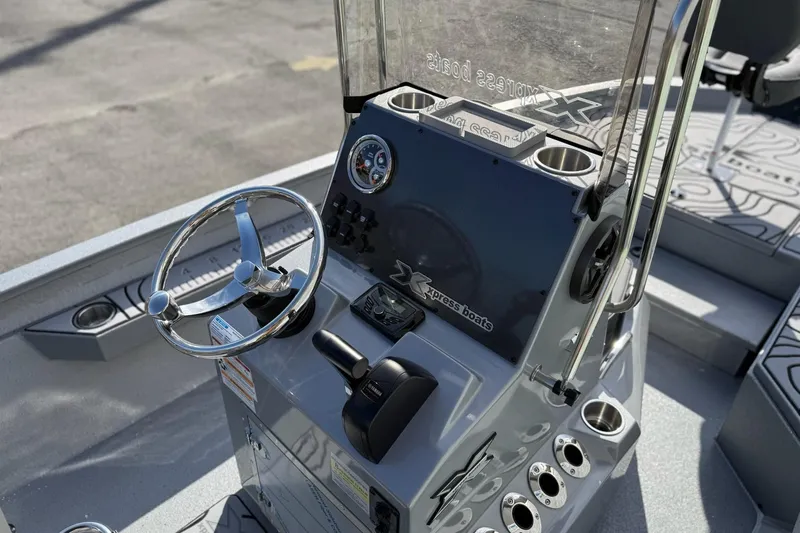 Slide: The Image of 2026 Xpress H20B Bay boat console with steering wheel and controls. - 13
