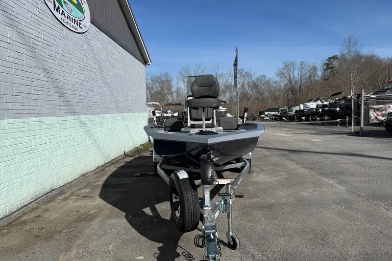 Slide: The Image of 2026 Xpress H20B Bay boat on trailer outside a building. - 3