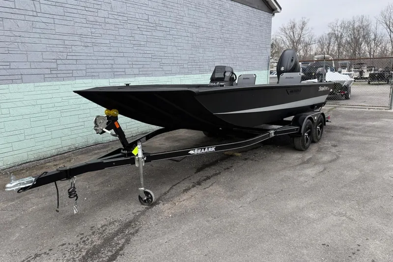 Slide: The Image of 2026 SeaArk Shadow 20 boat on trailer in front of gray wall. - 2