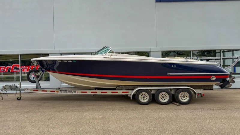 The Image of 2006 Chris-Craft Launch 28 boat on trailer in front of building. - 1