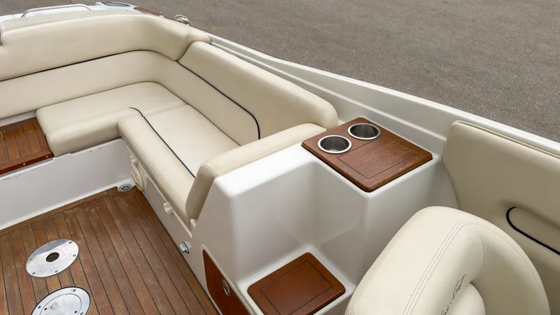 Slide: The Image of Interior of a 2006 Chris-Craft Launch 28 with beige seats and wood accents. - 14