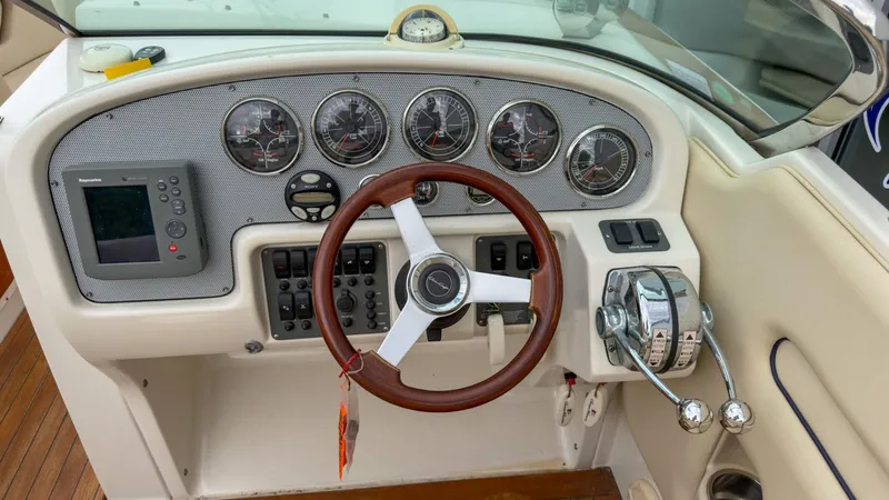 Slide: The Image of 2006 Chris-Craft Launch 28 boat helm with wooden steering wheel. - 24