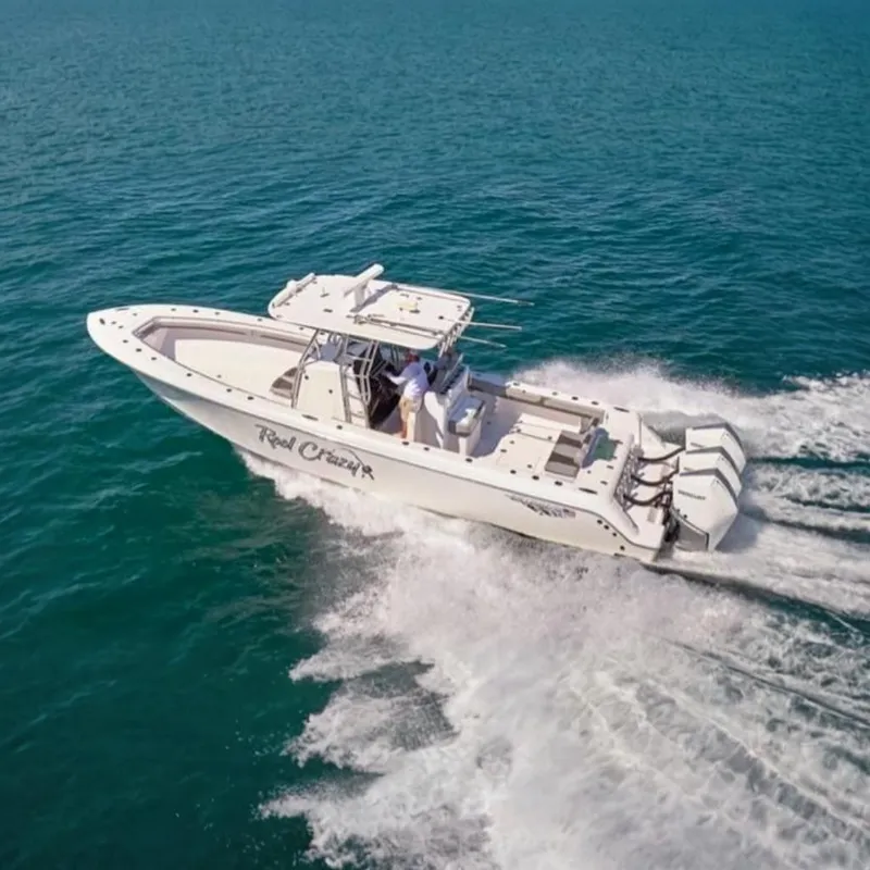 The Image of 2022 Bluewater 355e boat cruising on open water, featuring triple outboard engines. - 0
