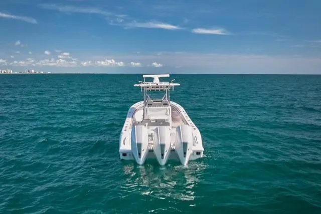 Slide: The Image of 2022 Bluewater 355e boat on open ocean under clear blue sky. - 13