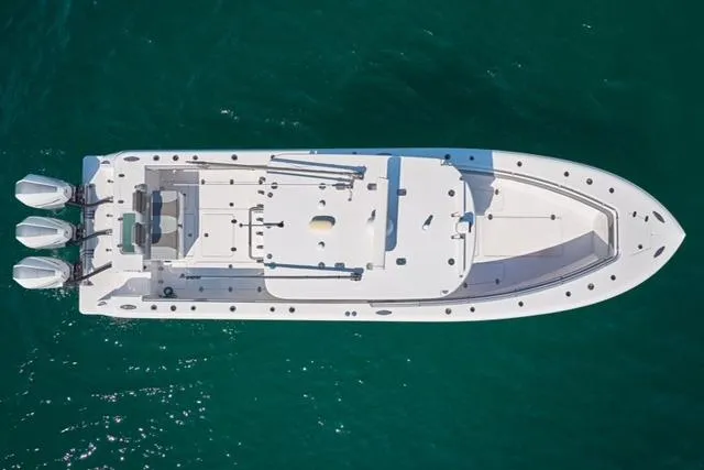 Slide: The Image of Aerial view of 2022 Bluewater 355e boat with triple engines on clear water. - 4