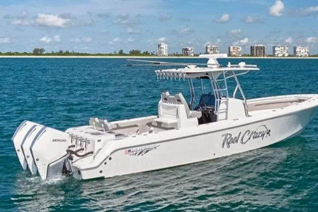 Slide: The Image of 2022 Bluewater 355e boat on open water with city skyline in background. - 7