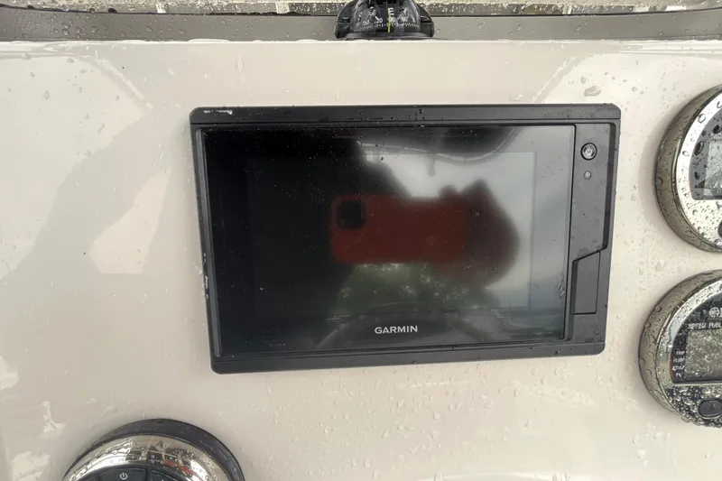 Slide: The Image of Garmin display on 2020 Robalo R200 Center Console boat dashboard with raindrops. - 10