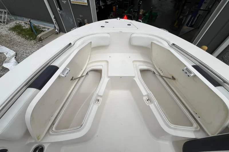 Slide: The Image of 2020 Robalo R200 Center Console boat with open storage compartments. - 14