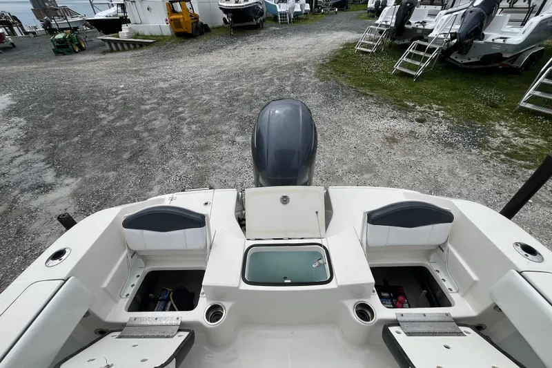 Slide: The Image of 2020 Robalo R200 Center Console boat interior with storage compartments and engine view. - 4