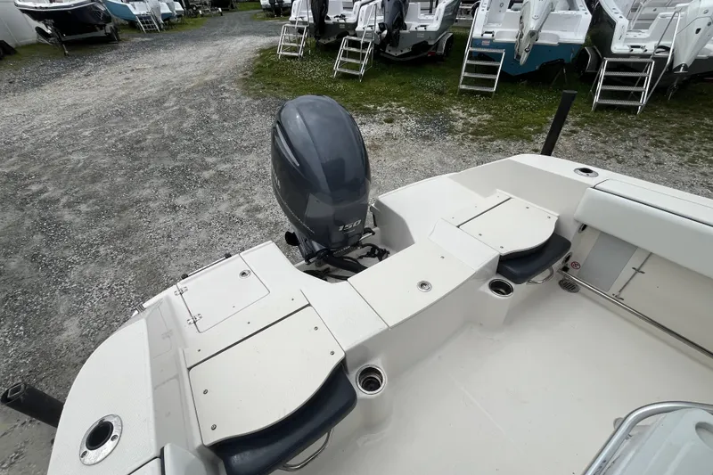 Slide: The Image of 2020 Robalo R200 Center Console boat with outboard motor in a gravel lot. - 6