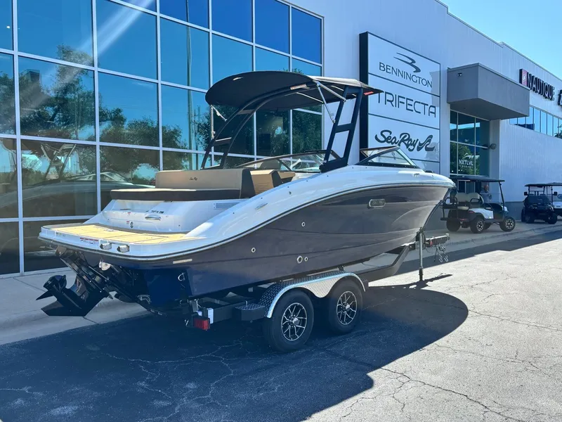 Slide: The Image of 2026 Sea Ray SPX 210 boat outside a showroom. - 2