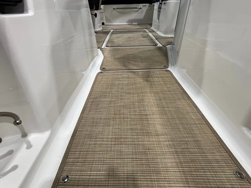 Slide: The Image of Interior of Sea Ray SPX 210 boat, carpeted flooring, year 2026. - 25
