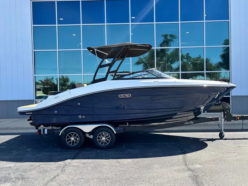 Slide: The Image of 2026 Sea Ray SPX 210 boat parked by glass building. - 3