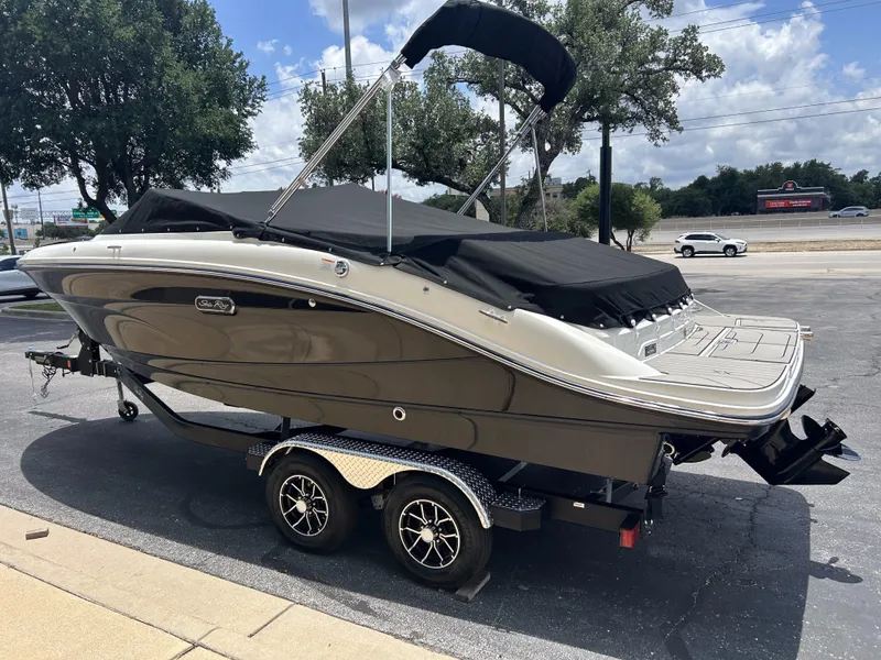 Slide: The Image of 2026 Sea Ray SPX 210 boat on trailer, covered, in parking lot. - 6