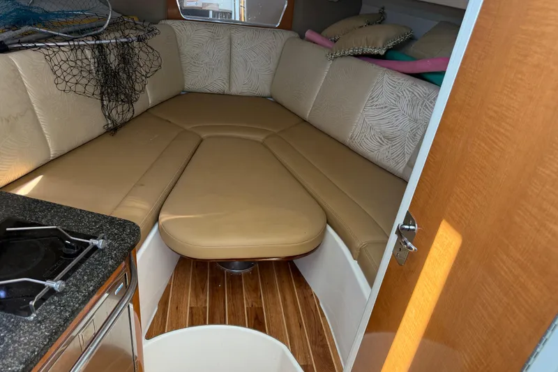 Slide: The Image of 2007 Robalo R305 Walkaround cabin interior with beige seating and wooden flooring. - 11